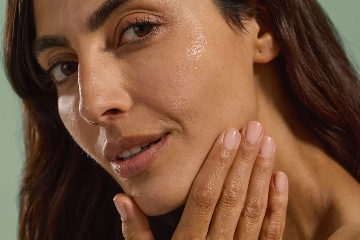 Dermatologist examining facial skin texture during a barrier-focused consultation