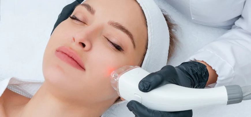 Dermatologist examining uneven facial pigmentation in natural indoor light